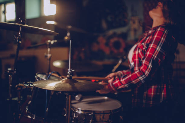 istock Brunette woman playing drums 1084100828