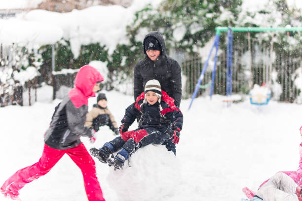 istock Kids playing in snow. Children play outdoors in winter snowfall. 1084103736