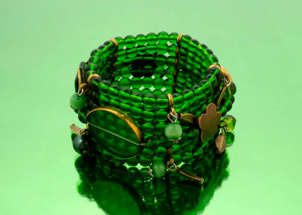 Oriental beads bracelet on green mirrorlike background
