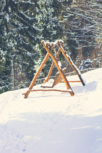 istock Wooden swing in the snow 1084105248