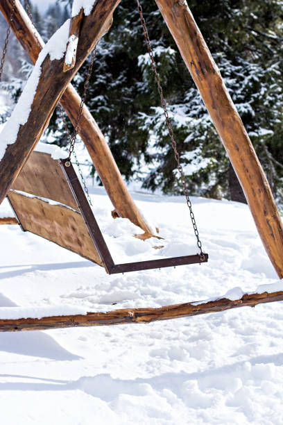 istock Wooden swing in the snow 1084105264