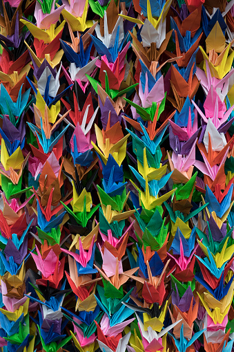 Bunches of colorful Origami paper crane birds full frame close up