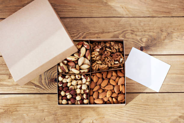 istock Gift box, box of nuts - hazelnut, cashew, dried daddy, dried pineapple. 1084106104