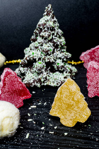 istock Chocolate Christmas tree, marmalade colorful trees on black background 1084107036