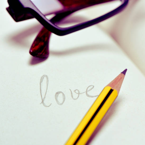 istock eyeglasses and word love in a notebook 1084109140