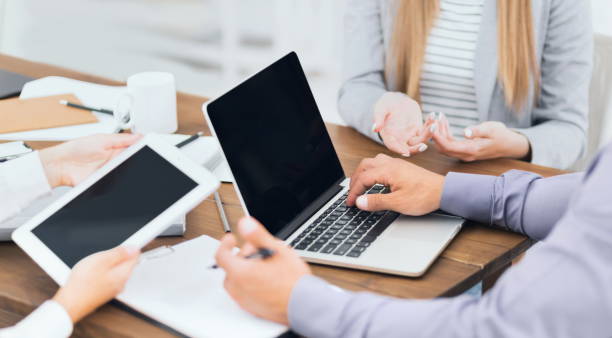 istock Business people using tablet and laptop at business meeting 1084111420