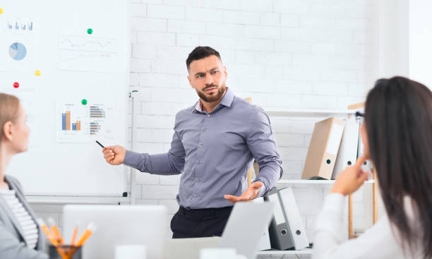 istock Upset boss showing financial reports with work results 1084111430