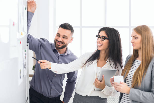 istock Business team discussing results near flipboard in office 1084111446