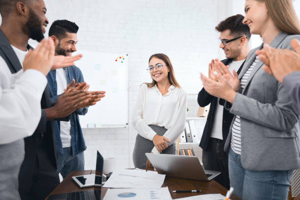 istock Business team congratulating successful female manager with applause 1084111552