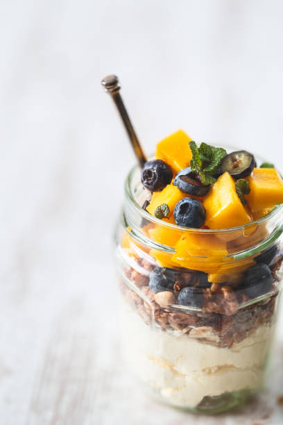 istock Healthy Breakfast with Granola or Muesli, Blueberries, Coconut yogurt and Mango 1084114624