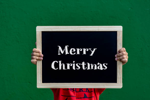 istock Merry Christmas written blackboard by a children 1084114776