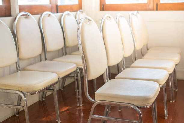 istock White chairs arranged in a seminar room with light from windows 1084115226