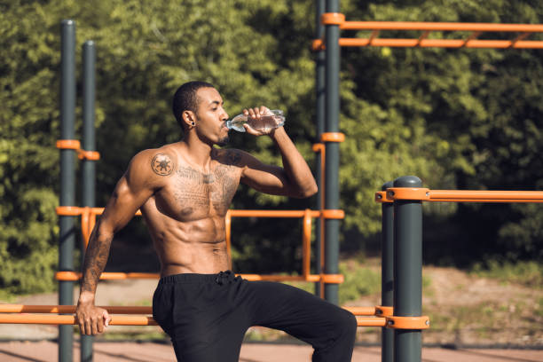 istock Athlete drinking water and relaxing after intense workout 1084119872