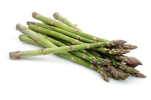 Green asparagus sticks isolated on white background. Studio shot.