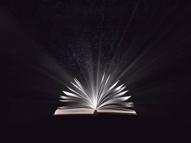 istock An open magic book, bewitched book glows in the darkness, magic light. Education. Dreamy image of a fairytale 1084125188