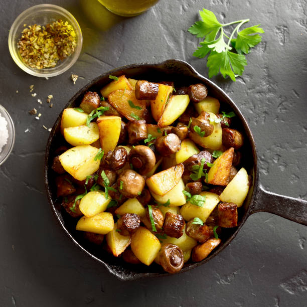 istock Fried potatoes with mushroom and sausages 1084126472