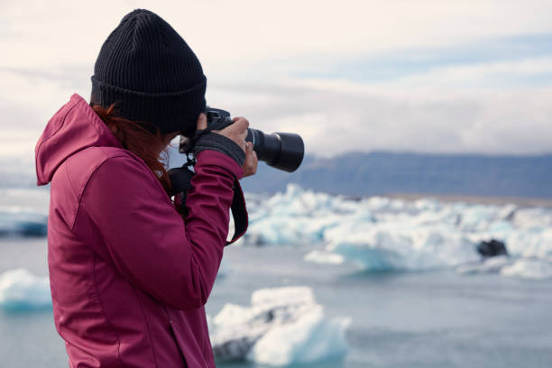 istock Female photographer at glacier lagoon 1084126618