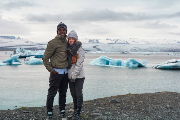 istock Happy multi ethnic couple enjoying glacier lagoon 1084126788