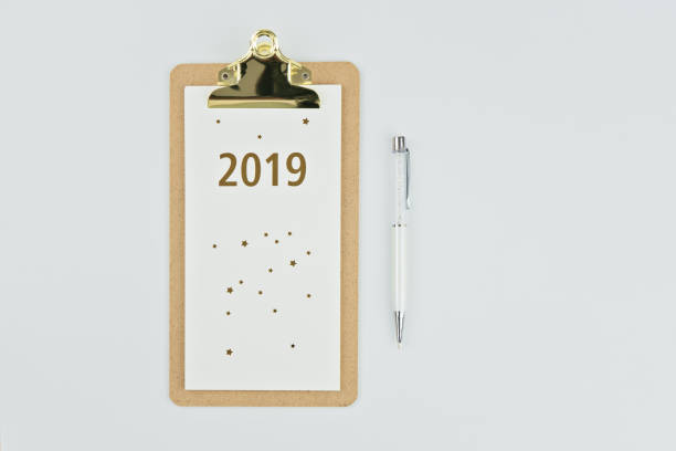 istock New year 2019 calender with notebook and pen on white 1084127168