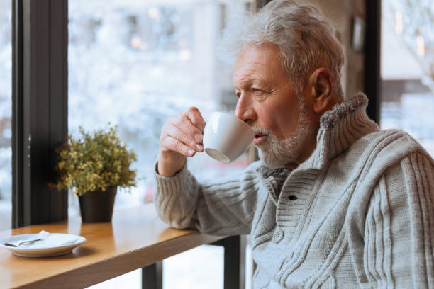 istock Senior man drinking coffee in a cafe 1084129408