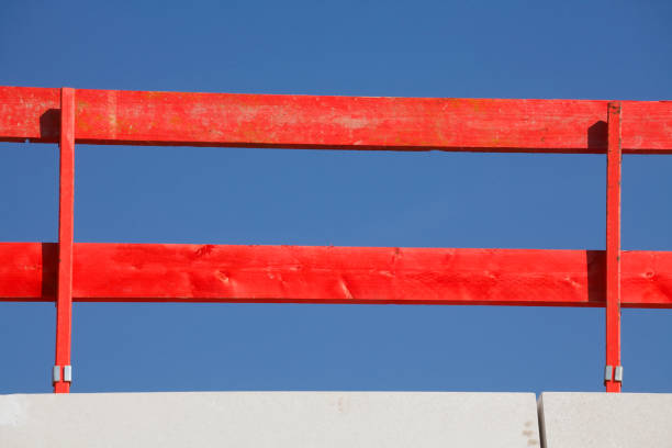 Red wooden construction fence, blue sky