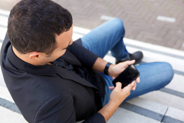 istock man sitting with mobile phone 1084131866