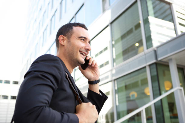istock businessman talking on mobile phone by city building 1084131968