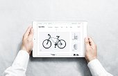 Hands holding tablet with sport webstore mock up on screen