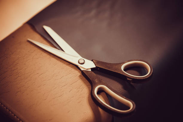Scissors on the material during upholstering stock photo