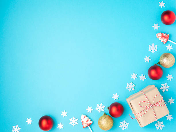 istock Christmas composition. Frame from red balls, gift, lollipops and snowflakes on pastel blue background. Christmas, winter, new year concept. Flat lay, top view, copy space 1084137462