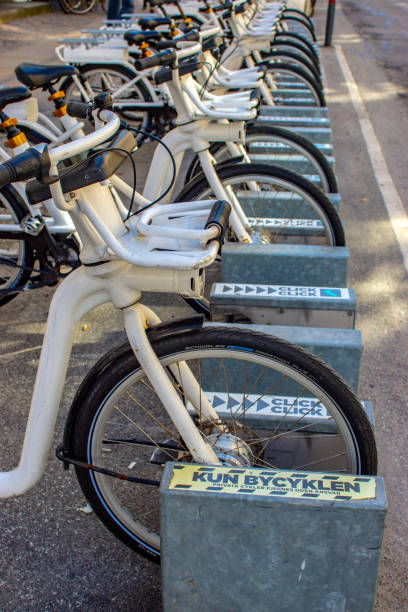 City bikes (Bycyklen) in docking stations in Copenhagen, Denmark. the bikes are available for short term hire by commuters or tourists and can be left at other docking stations around the city.