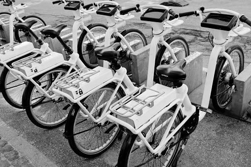 City bikes (Bycyklen) in docking stations in Copenhagen, Denmark. the bikes are available for short term hire by commuters or tourists and can be left at other docking stations around the city.
