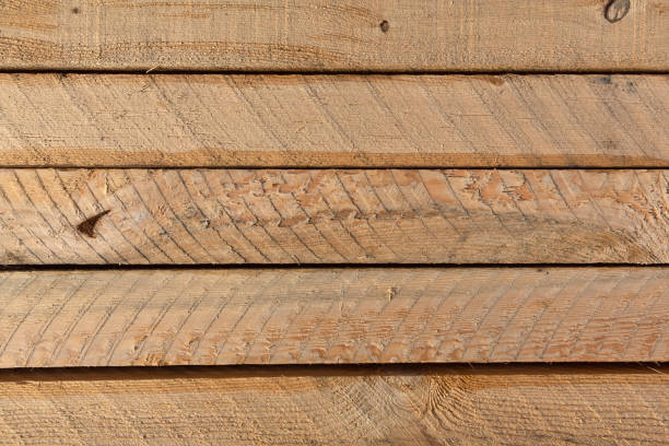 Several rough sawn lumber boards Top view of the surface of several rough sawn lumber boards. roughhewn stock pictures, royalty-free photos & images