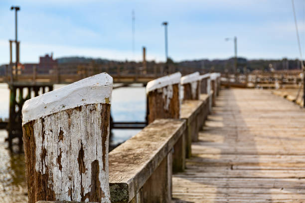 View of the old wood waterfront walkway and pilings at Wiscasset Maine in December.