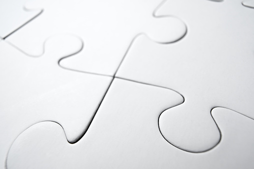 Puzzle pieces of jigsaw puzzle on a wooden surface