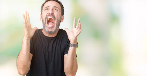 istock Handsome middle age hoary senior man over isolated background crazy and mad shouting and yelling with aggressive expression and arms raised. Frustration concept. 1084162026