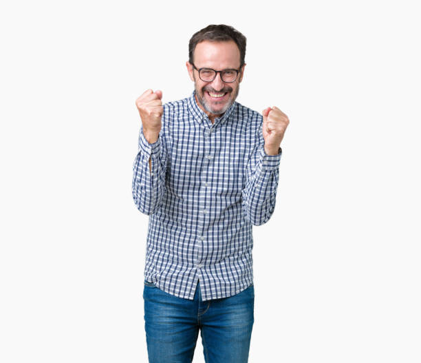 istock Handsome middle age elegant senior man wearing glasses over isolated background celebrating surprised and amazed for success with arms raised and open eyes. Winner concept. 1084162292