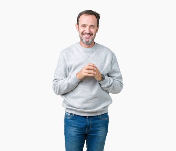 istock Handsome middle age senior man wearing a sweatshirt over isolated background Hands together and fingers crossed smiling relaxed and cheerful. Success and optimistic 1084162782