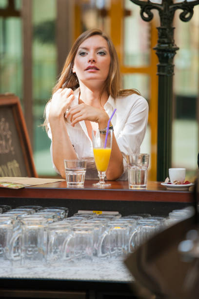 istock Woman sitting alone at bar 1084165478