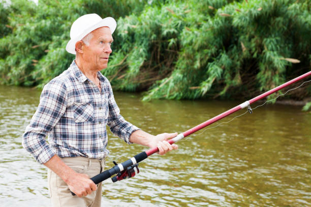 istock Mature man angling at riverside 1084165808