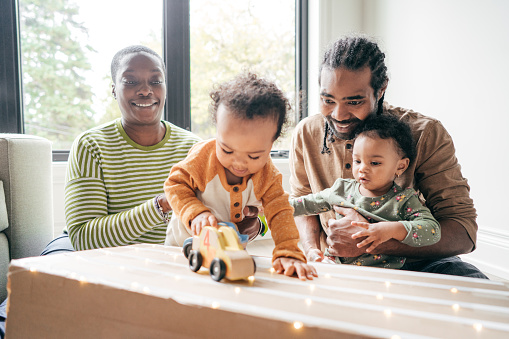 Two parents playing with their babies