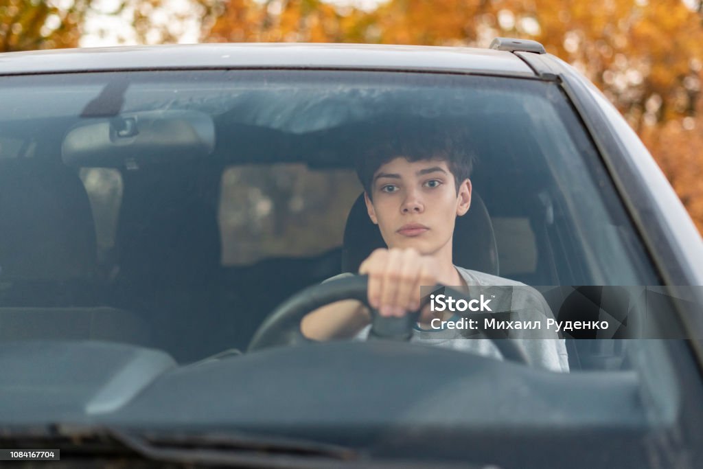 young teenager learns how to drive the car  f young teenager learns how to drive the car Driving Stock Photo