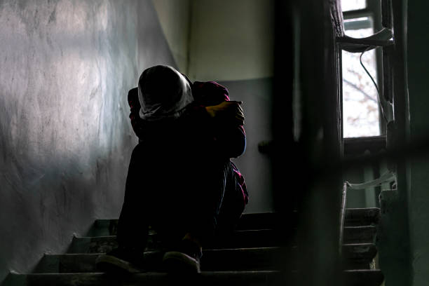 istock children problem, young kid sit on stairs on abandoned building  f 1084168250