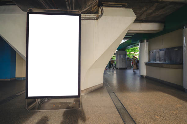 istock big blank billboard white LED screen vertical outstanding on bunting or concrete pillar side pathway walking to skytrain outdoor for display advertisement text template promotion new brand. 1084168422