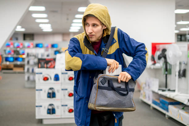 shoplifter in the electronic store supermarket stealing new gadget f stock photo