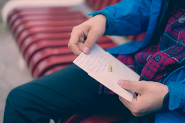 istock close up person open the received letter  f 1084168976