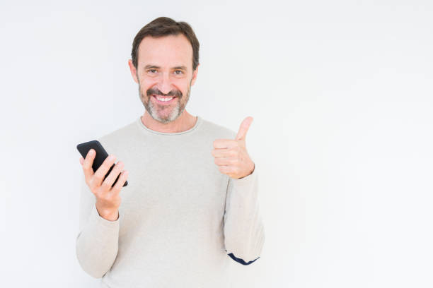 istock Senior man using smartphone over isolated background happy with big smile doing ok sign, thumb up with fingers, excellent sign 1084171544