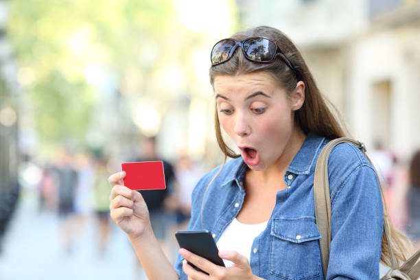 istock Surprised girl buying online and finding offer 1084172182