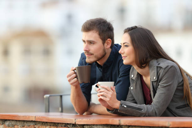 istock Couple relaxing drinking coffee in a balcony on vacation 1084172410