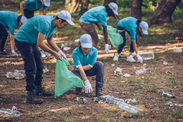 istock Volunteers with garbage bags in public park 1084172466